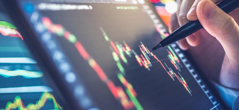 Trader reviewing candlestick charts and technical indicators on a digital trading platform, highlighting market analysis, price action monitoring, and informed trading decision making.