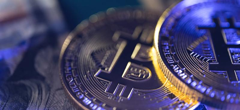 Close up view of Bitcoin cryptocurrency coins with detailed engravings and the Bitcoin symbol, representing digital assets, blockchain technology, cryptocurrency investing, and virtual currency trading markets.