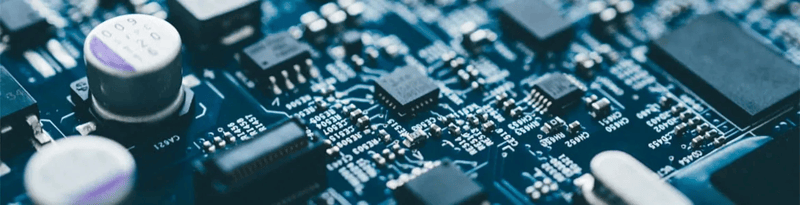 Close-up of a printed circuit board with electronic components and microchips mounted on it