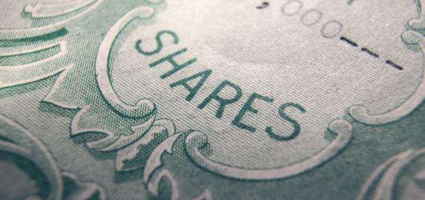 Close-up view of a printed share certificate with decorative border and the word shares in bold letters.