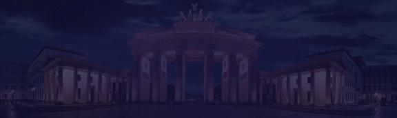 Brandenburg Gate in Berlin illuminated at night representing Germany’s economy, European markets, and financial strength