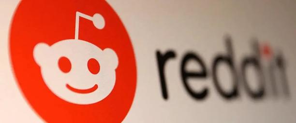 Reddit logo displayed on a screen with the Reddit brand name in the background