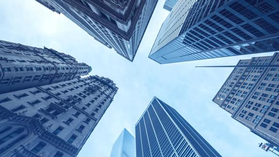 Low-angle view of financial district skyscrapers representing global finance, corporate growth, and economic strength