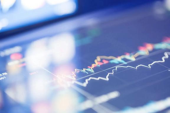 Close-up view of a digital trading chart showing colorful price trends and market data on a screen