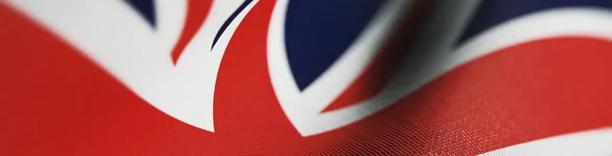Close up of the United Kingdom flag showing red, white, and blue colors in detail.