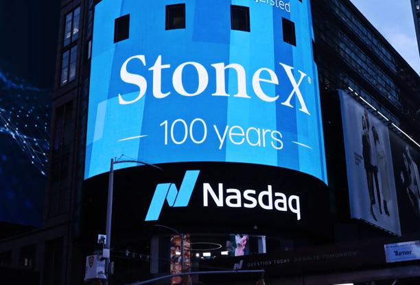 Large digital billboard in Times Square displaying Stonex 100 years celebration above Nasdaq logo.