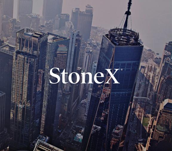 Aerial cityscape featuring tall skyscrapers with the StoneX logo prominently displayed across the center, symbolizing urban presence and corporate branding.