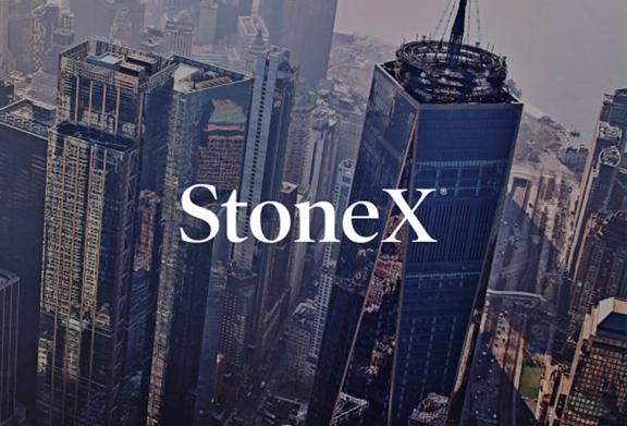 Aerial view of tall skyscrapers in a modern city with StoneX logo displayed prominently in the center