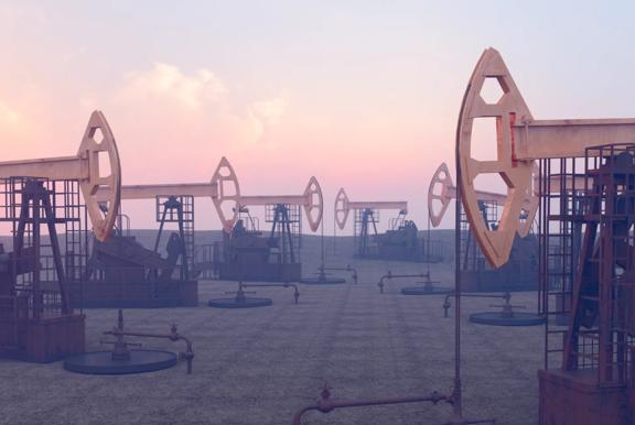 Image of several oil pump jacks operating in a field under a pink and blue sunset sky.