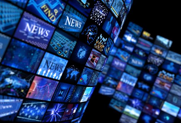 Digital wall of global news and media screens representing real-time financial information, technology, and market connectivity