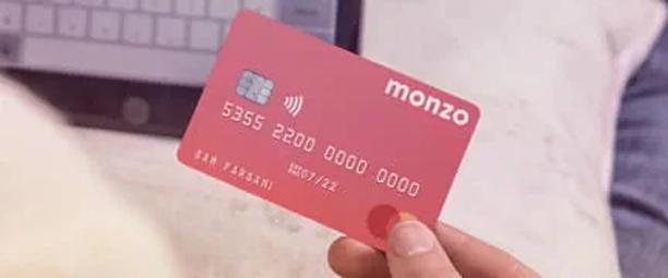 Fingers holding Monzo card