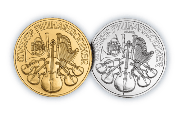 Gold and silver Austrian Philharmonic coins representing precious metal investment and commodity trading