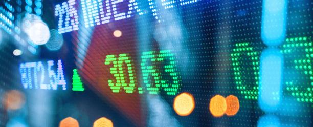 Digital stock market display board showing colorful financial data with upward trend indicators