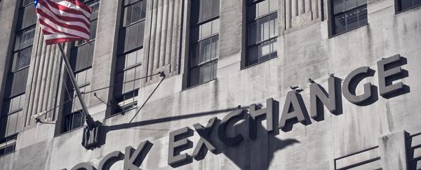 Exterior of stock exchange building with American flag and classical architecture