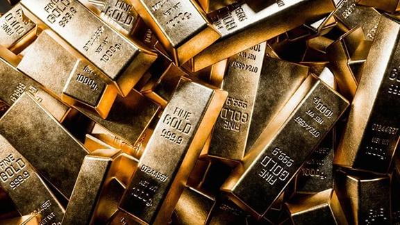 Stacked fine gold bars labeled 999.9 purity and 1000g weight